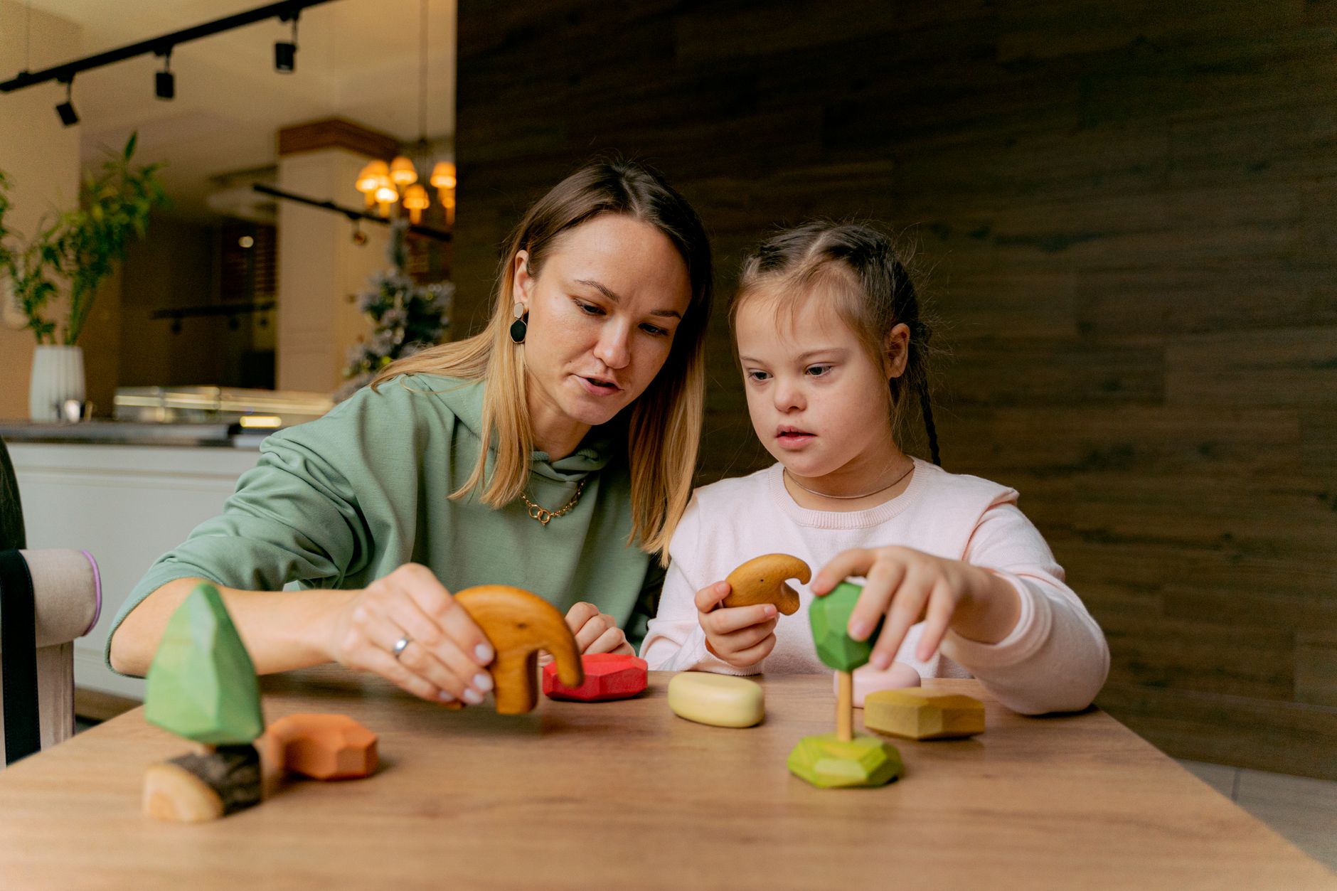Parent gently supporting a young child at home