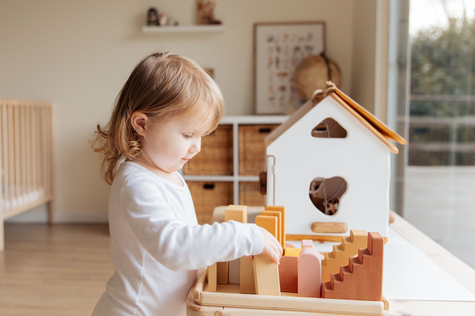 Child playing with wooden blocks in calm sensory activity